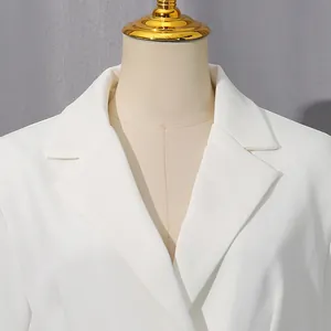 Close-up of the notched lapel and shoulder of a crisp white summer blazer