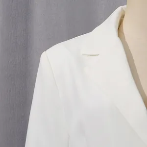 Macro view showing the lapel detail of a professional white blazer on a mannequin