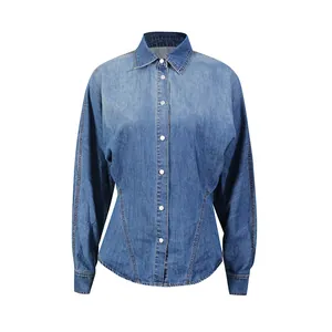 Close-up of a vintage wash denim shirt with cinched waist and white buttons