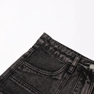 Detailed macro close-up of black washed denim skirt pocket and waist area stitching.