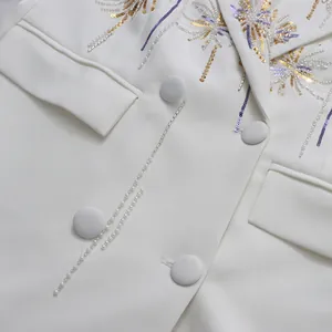 Macro view of elegant vintage fireworks gold-gilt embroidery on a white blazer.