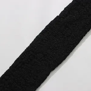 Close-up macro view of the intricate black floral lace pattern on a sheer bodysuit fabric