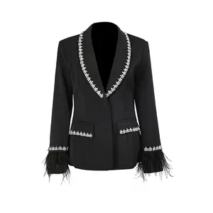 Close-up detail of a luxury black French style blazer with rhinestone trim and feather cuffs