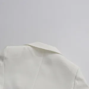 Close-up of the tailored collar and shoulder seams of an elegant white blazer jacket
