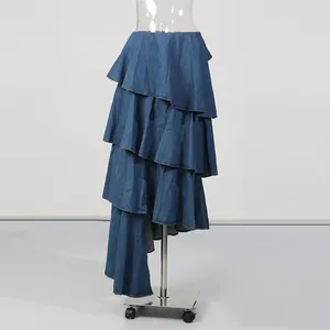 Detailed view of a vintage blue tiered denim long skirt presented on a clear mannequin stand