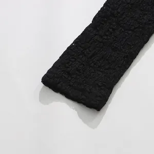 Detailed macro view of black textured lace fabric for a women's summer bodysuit