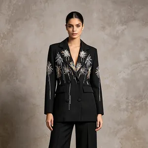 Detailed view of an elegant black blazer featuring golden firework embroidery and a slim fit