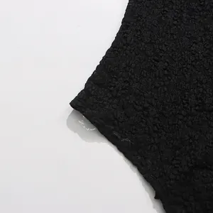 Close-up of black floral lace fabric texture for sexy see-through bodysuit garment