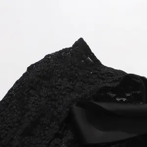Close-up detail of premium black floral lace and satin ribbon on a sexy bodysuit