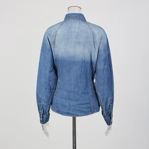 Detailed back view of a vintage faded blue denim shirt featuring raglan sleeve design