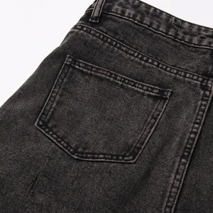 Close-up detail of the back pocket area on a washed black denim high waist skirt