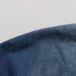 Detailed macro view showing the high-quality blue denim fabric texture and twill weave