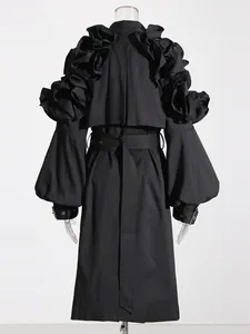 Detailed back view of a high-end black trench coat with dramatic ruffle shoulders and puff sleeves