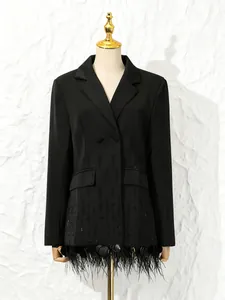 Elegant black blazer with shell stitching and ostrich feather hem display on mannequin.