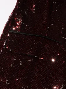 Close-up of burgundy sequined jacket detail showing shimmering sequins and pocket flap