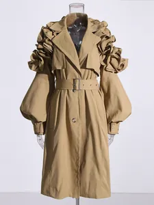 Front view detail of a khaki trench coat featuring ruffled shoulders and puff sleeves