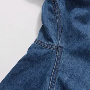 Close-up detail of vintage blue denim shirt showing high-quality stitching and fabric
