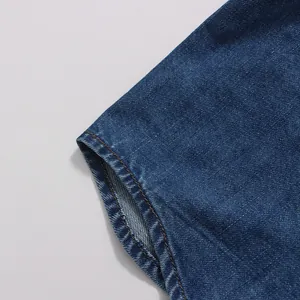 Close-up detail of high-quality vintage blue denim fabric with neat contrast stitching