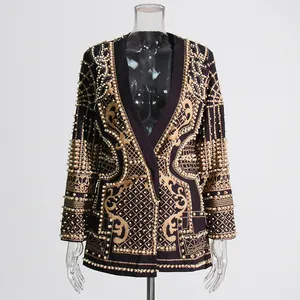 Detailed view of the royal style blazer with heavy gold print and pearl beadwork.