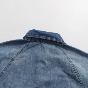 Close-up detail of a blue vintage denim shirt collar featuring high-quality stitching