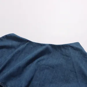 Close-up of high-quality denim fabric texture on a retro shirt or skirt.