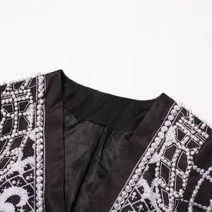 Close-up detail of luxury royal style beaded blazer collar with white pearl accents.