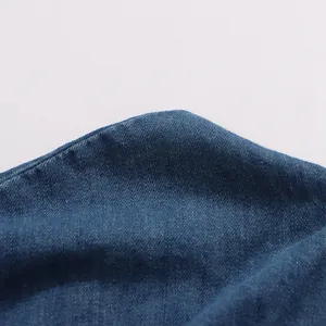 Detailed macro view showing the textured blue denim fabric of a vintage maxi skirt