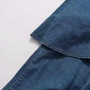 Close-up of vintage blue denim layered skirt showing detailed fabric texture and stitching.