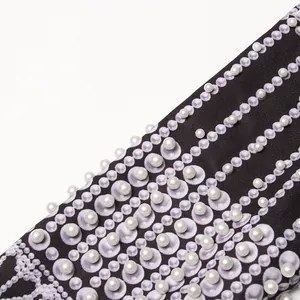 Close-up of elegant palace style pearl-studded printing detail on women luxury suit jacket
