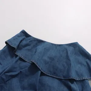 Close-up detail of the ruffled neckline on a blue denim shirt from a vintage set