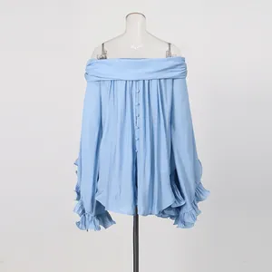 Detail view of light blue off-shoulder blouse with tiered ruffle sleeves and buttons