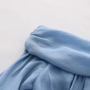 Detailed macro view of light blue ruffled top fabric texture and elastic gathers
