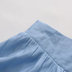 Close-up of light blue textured fabric detailing French style summer vacation set