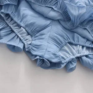 Detailed macro shot of light blue French resort style ruffled crepe fabric texture