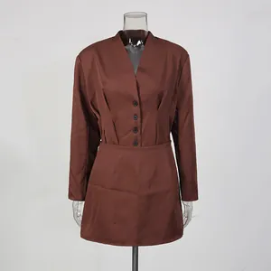 Front view detail of a sophisticated brown two-piece blazer and mini skirt set on a mannequin