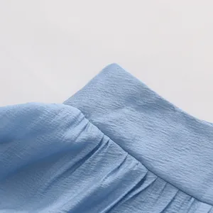 Close-up of light blue French style vacation set showing textured fabric and ruffle detail