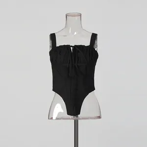 Detail view of black corset-style bodysuit with ruched bust and drawstring tie front.