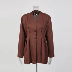 Detail shot of brown v-neck cinched waist blazer with button-down front on mannequin.