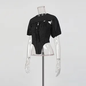 Detail view of black puff sleeve shrug and corset bodysuit two-piece set on mannequin.