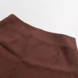 Close-up view showing the high-waisted stitching and darts on a brown bodycon skirt