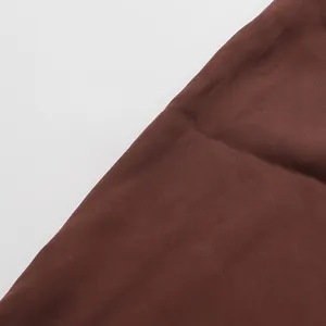 Detailed close-up showing the smooth texture of brown fabric for elegant skirt sets
