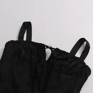 Detail of black camisole top featuring gathered bust and adjustable drawstring tie