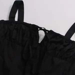 Close-up detail of black camisole top with gathered bust and tie-up drawstring design
