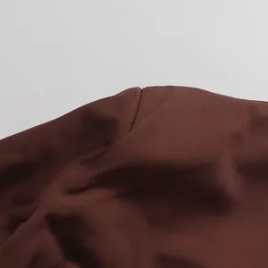 Close-up detail showing the smooth seam and high-quality brown fabric on elegant suit jacket