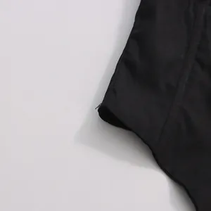 Close-up detail showing the black fabric texture and stitching of a summer bodysuit set