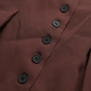 High-quality macro close-up of dark buttons on elegant brown tailored suit fabric