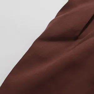 Close-up detail of high-quality brown fabric texture for elegant summer women's suit set