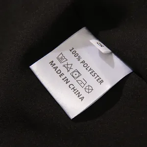 Close-up of garment wash label showing 100% polyester material and care instructions
