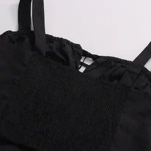 Detailed view of the smocked elastic back on a stylish black cotton camisole top