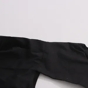 Close-up detail of the high-quality black fabric and seam stitching on a puff sleeve top